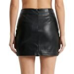 Back view of model wearing black faux leather mini skirt