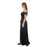 Side view of a model wearing an off-the-shoulder dress.