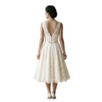 Back view of a model wearing a short wedding dress.