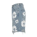 Side view of light blue distressed denim shorts with ripped detailing and frayed hem.