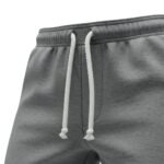 Close-up view of the elastic waistband and drawstring on soccer sweat pants, showing the flat tie string, stitched eyelets, and soft ribbed waistband fabric.