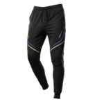 Blue and tan soccer training joggers laid flat, featuring an elastic waistband with drawstring, tapered legs with cuffed ankles, and a bold side stripe with logo icon.