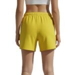 Back view of women’s soccer shorts laid flat, showing the wide elastic waistband, relaxed athletic fit, and smooth solid back panel.