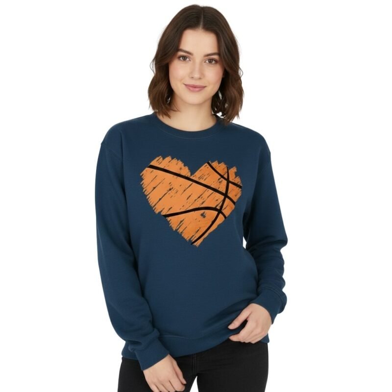 Model wearing a women’s basketball sweatshirt, standing to show the front view with crew neckline, long sleeves, ribbed hem, and small logo icon on the chest.