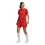 Model wearing a women’s soccer skort, standing to show the mid-rise elastic waistband, A-line skirt, and built-in shorts for full-coverage athletic movement.