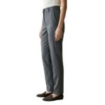 Side view of a model wearing women’s tailored trousers.
