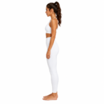 Side view of model wearing compression leggings showing fit, side pocket, and waistband for women's sports and activewear