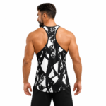 Back view of a muscular male model wearing a custom black and white graphics stringer tank top by Eco Jersey, highlighting the deep Y-back racerback cut, bold abstract graphic print, and athletic back silhouette