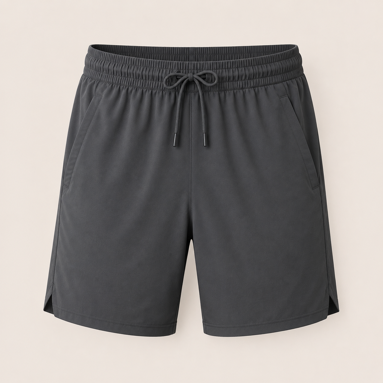Custom training shorts manufacturer showing men's dark grey lightweight training shorts with elastic waistband, drawstring, and side pockets on a beige background