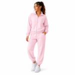 Female model wearing the super soft women's velour tracksuit in light pink colour option with zip-up mock-neck hoodie and tapered jogger sweatpants for colour reference