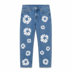 Flat lay of kids blue denim jeans with all-over white daisy floral patch embroidery on a transparent background