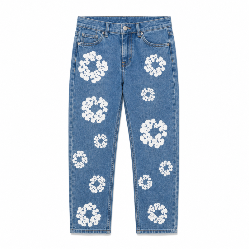 Flat lay of kids blue denim jeans with all-over white daisy floral patch embroidery on a transparent background