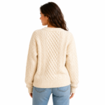 Back view of a female model wearing a cable-knit oversized women's pullover sweater showing the rear silhouette, back knit pattern, and overall drape of the garment