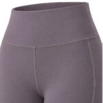 Close-up view of the high-waisted waistband and upper thigh area of a pair of solid grey-purple women's yoga leggings, showing smooth, stretchy fabric with visible light grey stitching.